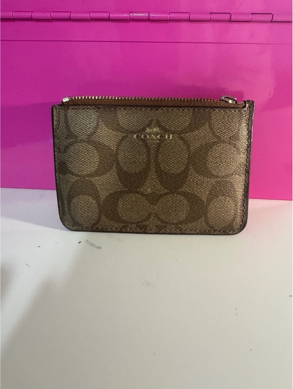 C50. a Coach Mini Skinny ID Case in Signature Canvas,